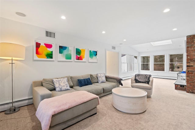 living room featuring light colored carpet, vaulted ceiling with skylight, and a baseboard radiator