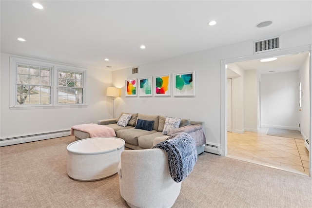 tiled living room with a baseboard heating unit