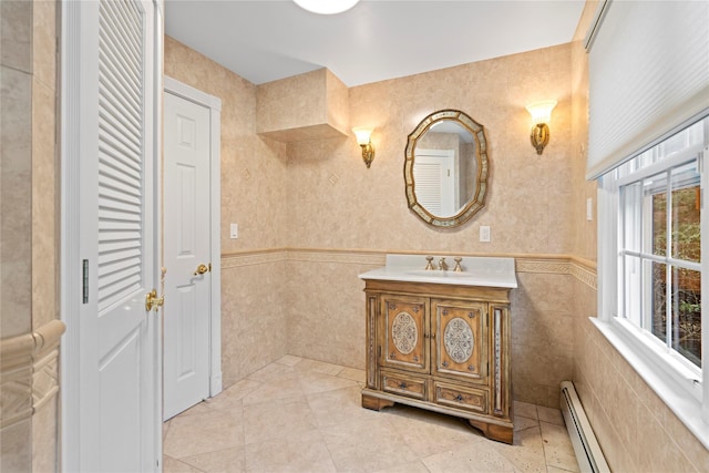 bathroom featuring tile walls, a baseboard heating unit, vanity, and tile patterned flooring