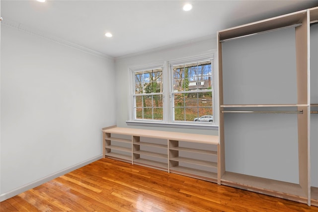 interior space featuring light wood-type flooring and crown molding