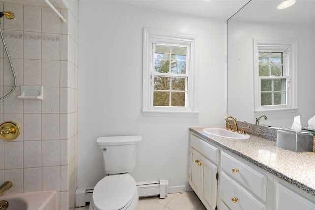 bathroom featuring baseboard heating, a wealth of natural light, and tile patterned flooring