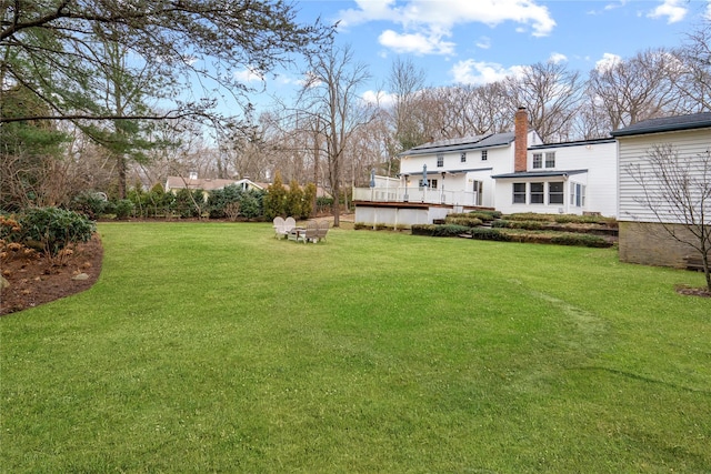 view of yard with a wooden deck