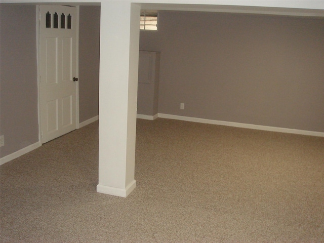 basement featuring light colored carpet