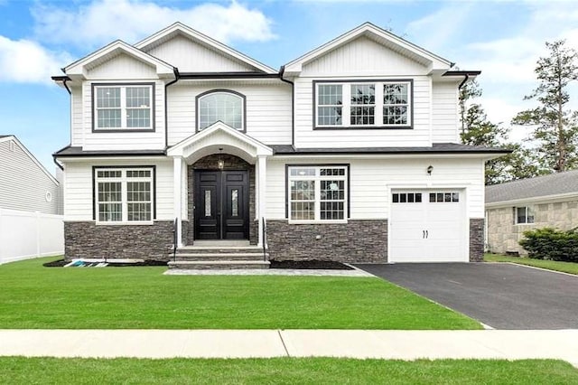 craftsman inspired home with a garage and a front yard