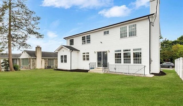 rear view of house with a lawn