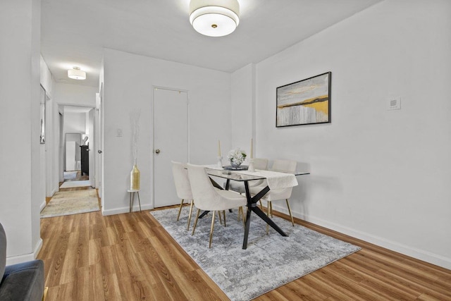 dining room with wood-type flooring