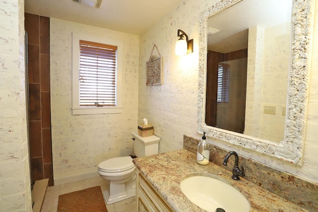 bathroom featuring tile patterned flooring, vanity, a shower, and toilet