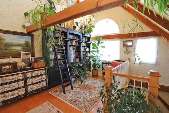 interior space with wood-type flooring, an inviting chandelier, and high vaulted ceiling