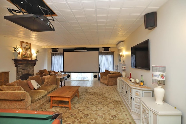 tiled home theater featuring a wall unit AC and a fireplace