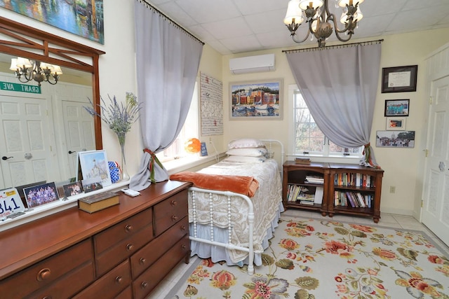 tiled bedroom featuring an inviting chandelier, a paneled ceiling, and a wall mounted AC