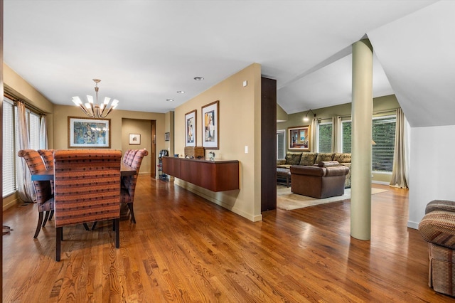 dining room featuring plenty of natural light, wood-type flooring, and a chandelier