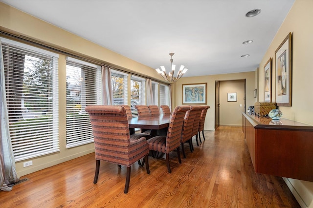 dining room with a chandelier and wood-type flooring