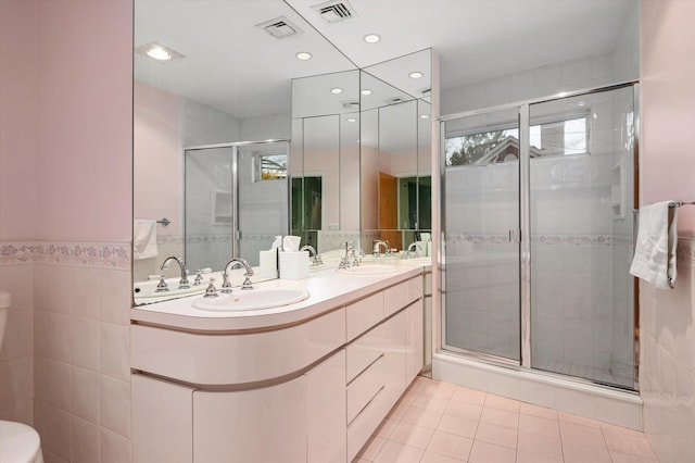 bathroom featuring tile patterned floors, walk in shower, vanity, and toilet