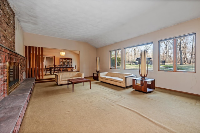 living area with lofted ceiling, carpet, a fireplace, and baseboards