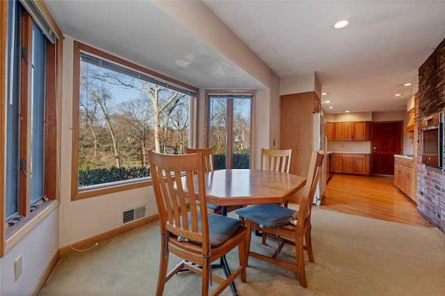 dining room featuring light carpet