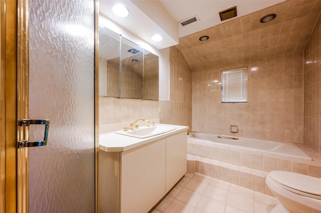 bathroom with tile patterned floors, toilet, tile walls, and vanity