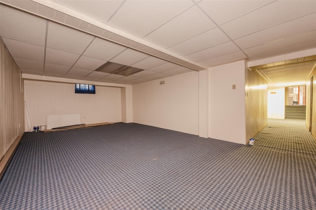 basement with wood walls and carpet floors