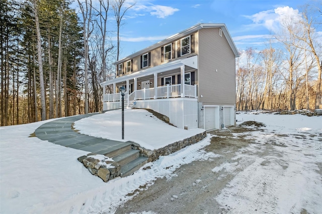 view of front facade with a porch and a garage