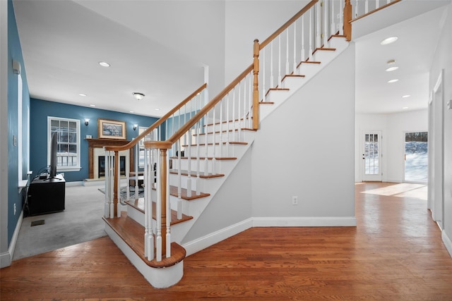 stairway with hardwood / wood-style floors