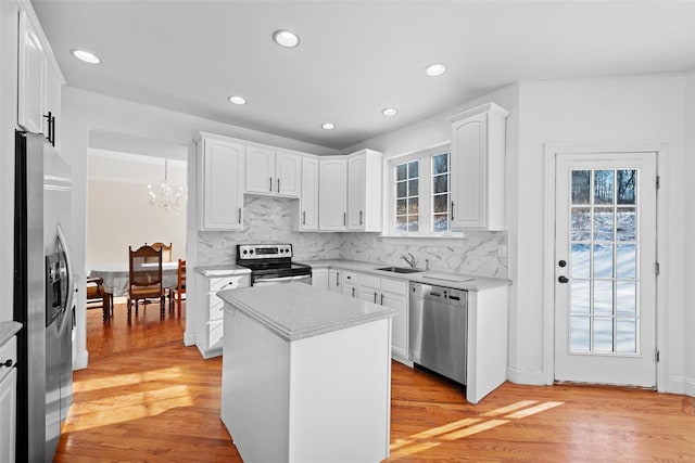 kitchen featuring white cabinetry, appliances with stainless steel finishes, and a center island