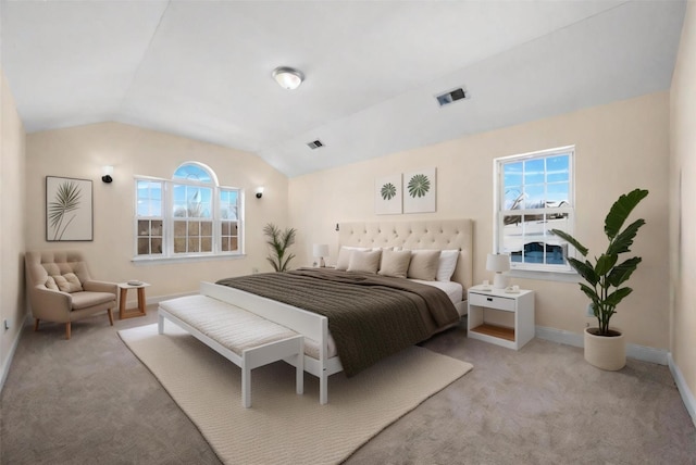 carpeted bedroom featuring vaulted ceiling and multiple windows