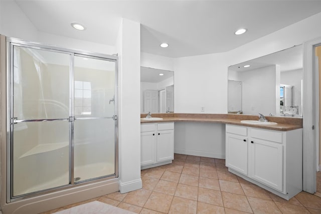 bathroom featuring vanity, a shower with shower door, and tile patterned floors