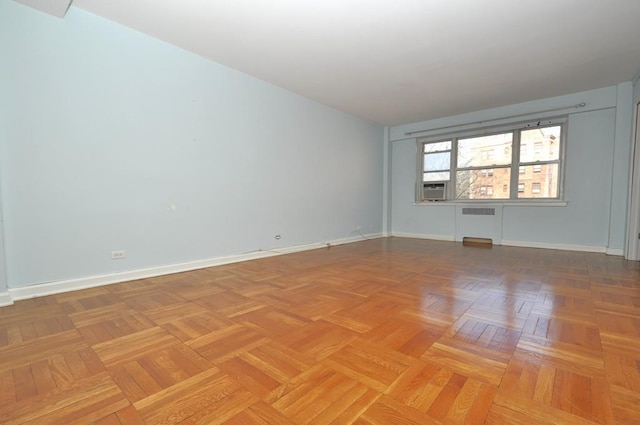 spare room with cooling unit and parquet flooring