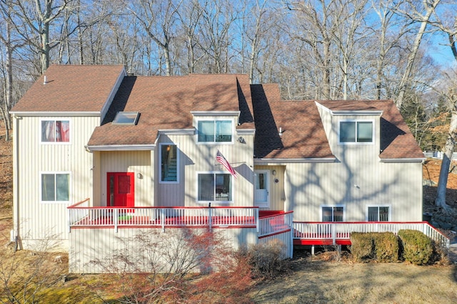 rear view of property featuring a deck