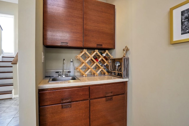 bar with sink and light tile patterned floors