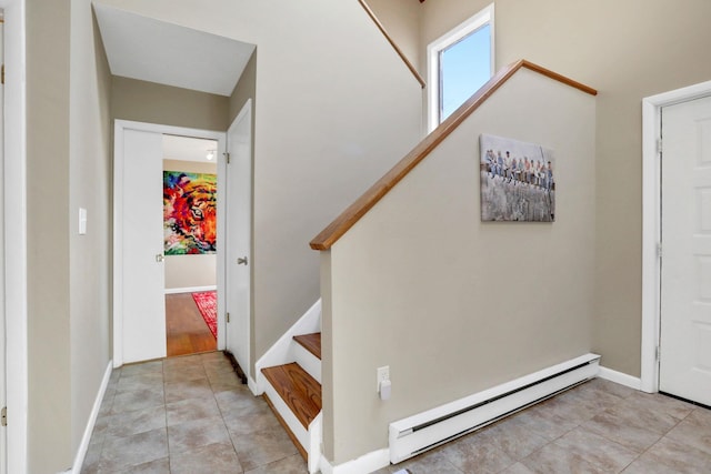 tiled foyer with a baseboard radiator