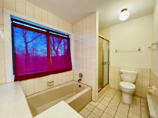 bathroom featuring tile patterned flooring, independent shower and bath, tile walls, and toilet