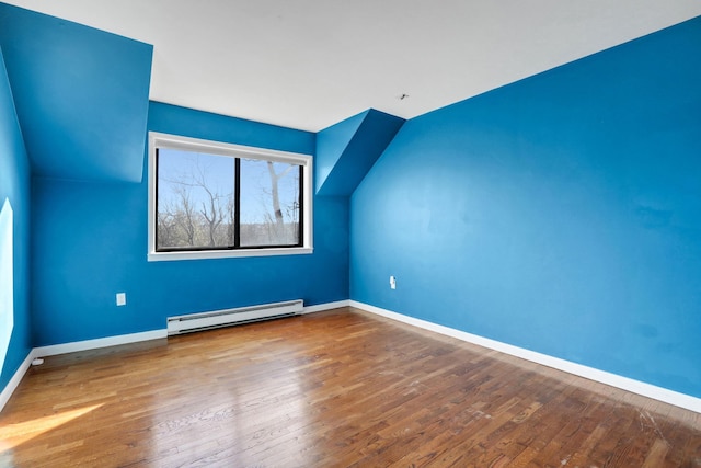 bonus room with baseboard heating, vaulted ceiling, and hardwood / wood-style flooring