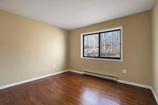 unfurnished room featuring a baseboard heating unit and dark wood-type flooring