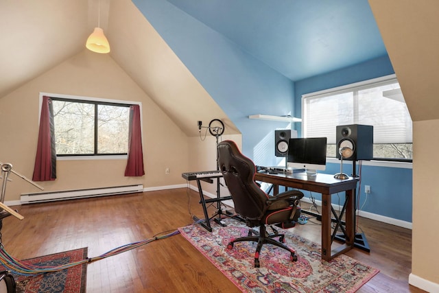 home office featuring vaulted ceiling, a baseboard radiator, plenty of natural light, and wood-type flooring