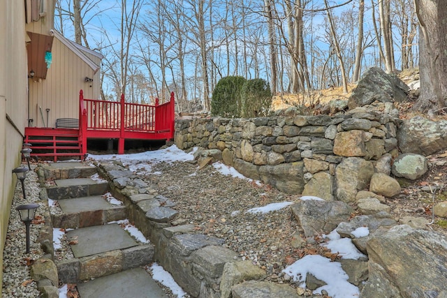 yard covered in snow with a wooden deck