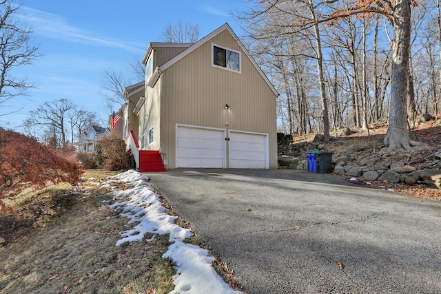 view of side of home featuring a garage