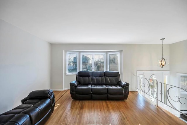 living room featuring an inviting chandelier and hardwood / wood-style floors