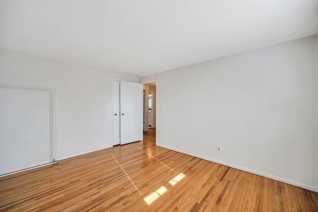 spare room with light wood-type flooring