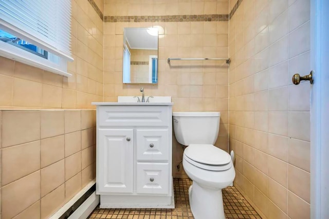 bathroom with vanity, toilet, tile patterned flooring, and tile walls