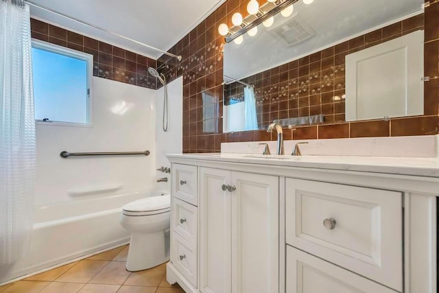 full bathroom featuring tile walls, tile patterned flooring, vanity, toilet, and shower / bath combo with shower curtain