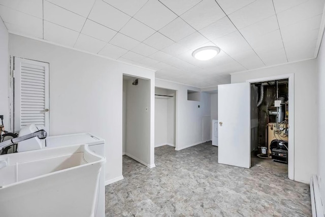 interior space with washer / dryer, a baseboard heating unit, and sink