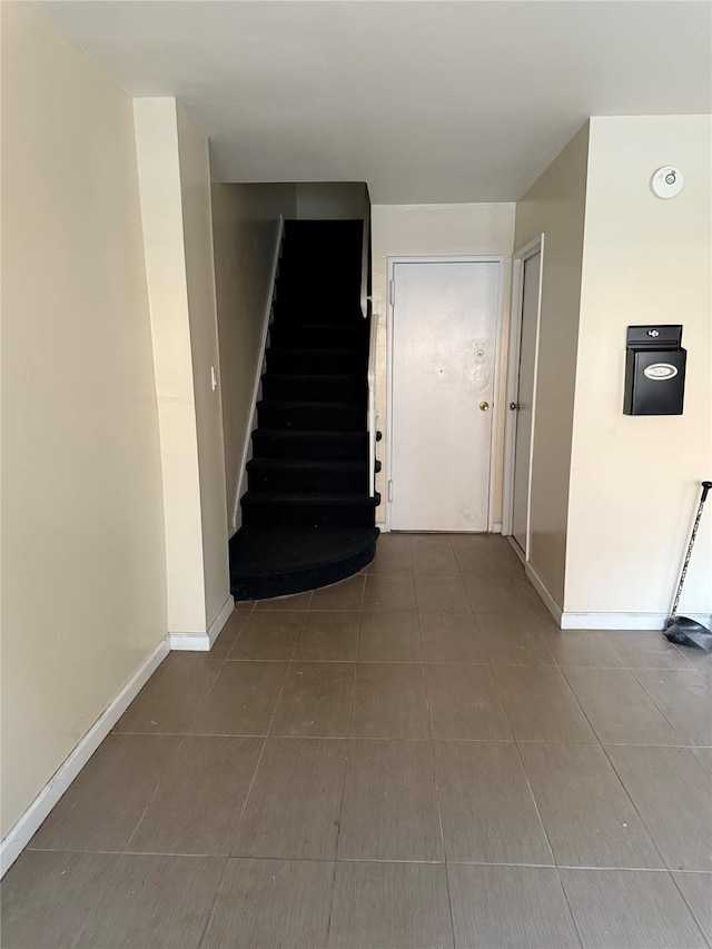 hall with tile patterned flooring