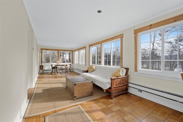 sunroom featuring a baseboard heating unit and plenty of natural light