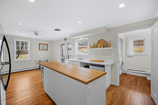 kitchen featuring light hardwood / wood-style floors, plenty of natural light, white cabinets, and dishwasher