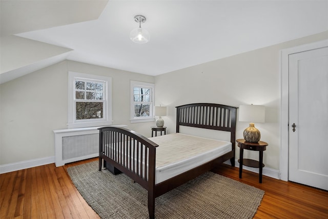 bedroom with wood-type flooring and radiator