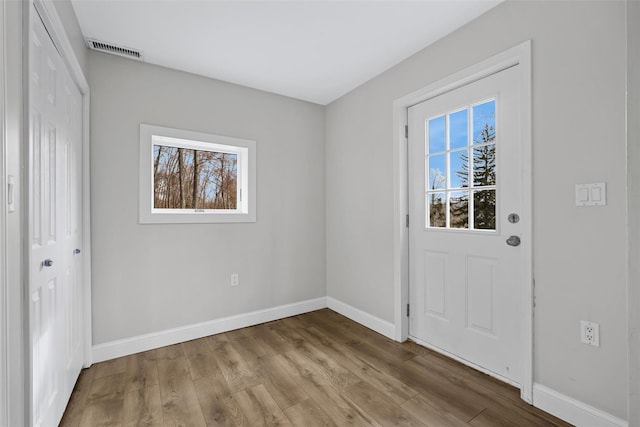 entryway with a healthy amount of sunlight and light hardwood / wood-style floors