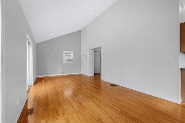 unfurnished living room featuring light hardwood / wood-style flooring and high vaulted ceiling