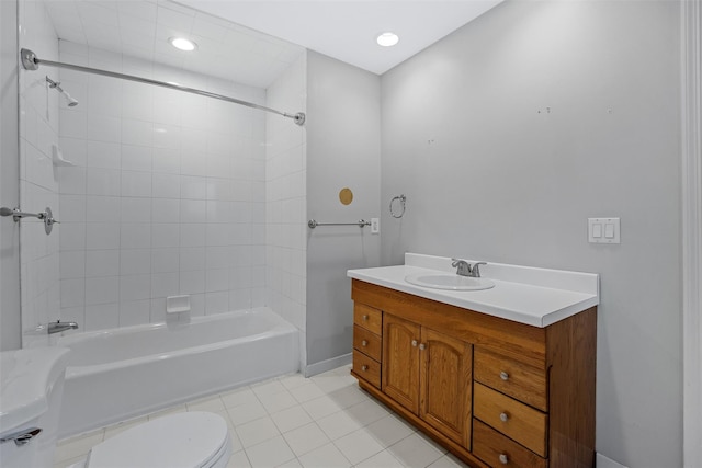 full bathroom with toilet, vanity, tiled shower / bath, and tile patterned flooring