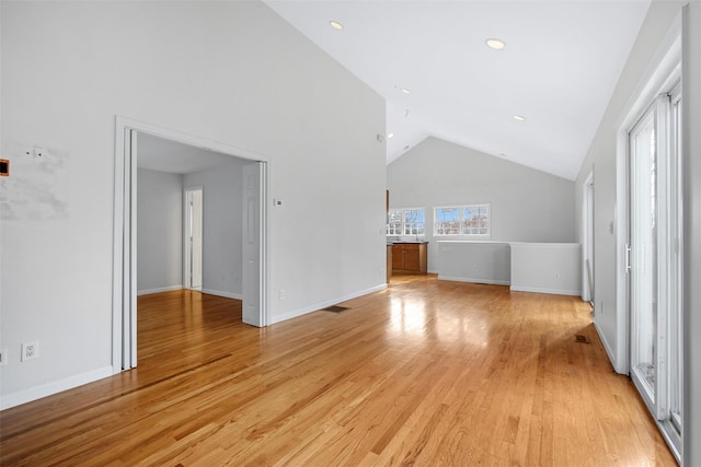 bonus room featuring light wood-type flooring and high vaulted ceiling