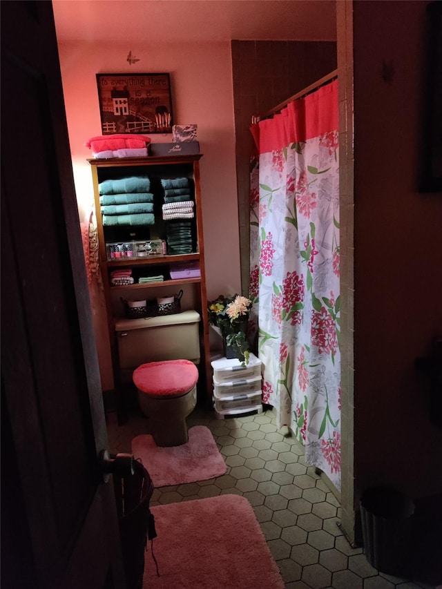 bathroom with toilet and tile patterned flooring